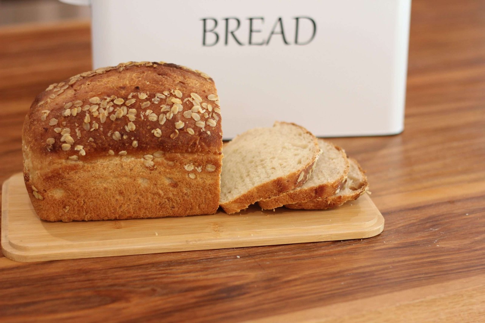 Loaf of homemade bread on cutting board sliced.