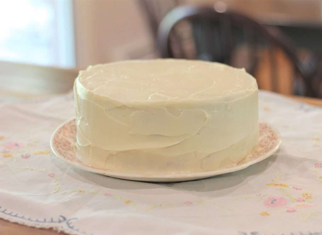 Best Sourdough Carrot cake with cream cheese frosting on counter.