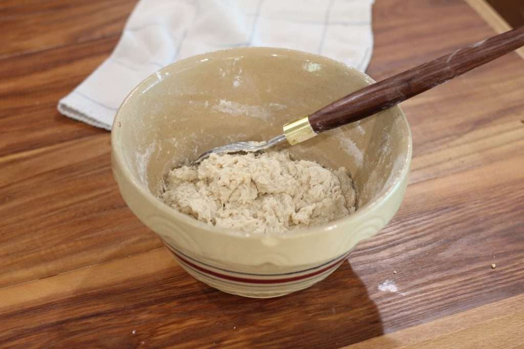 Sourdough dough in a bowl with wisk