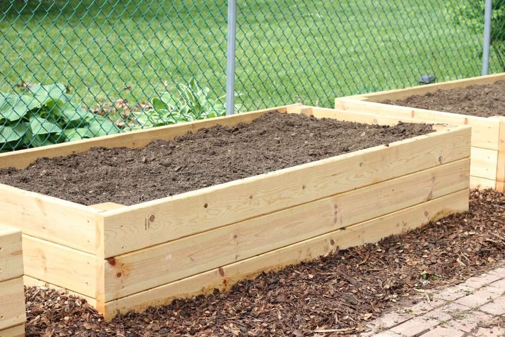 raised garden bed with just dirt in it.