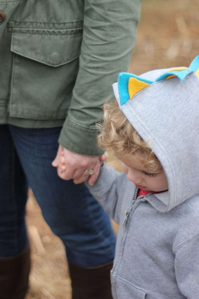 Mother holding son's hand