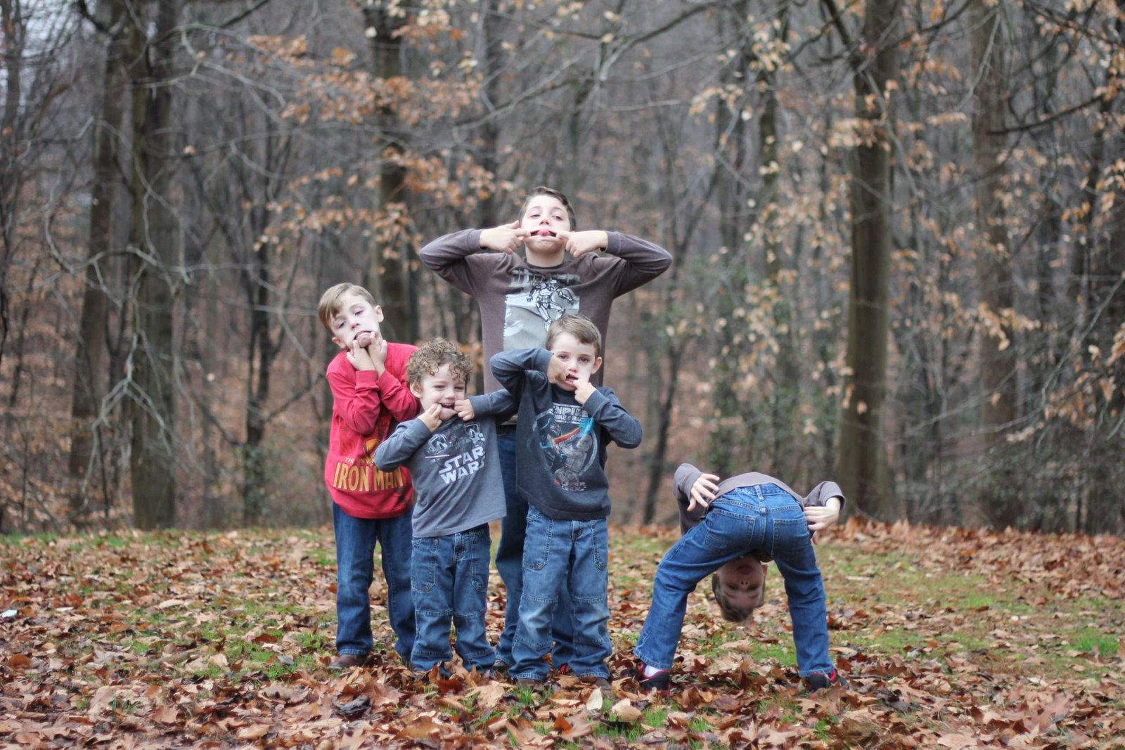 Five young boys posing for picture