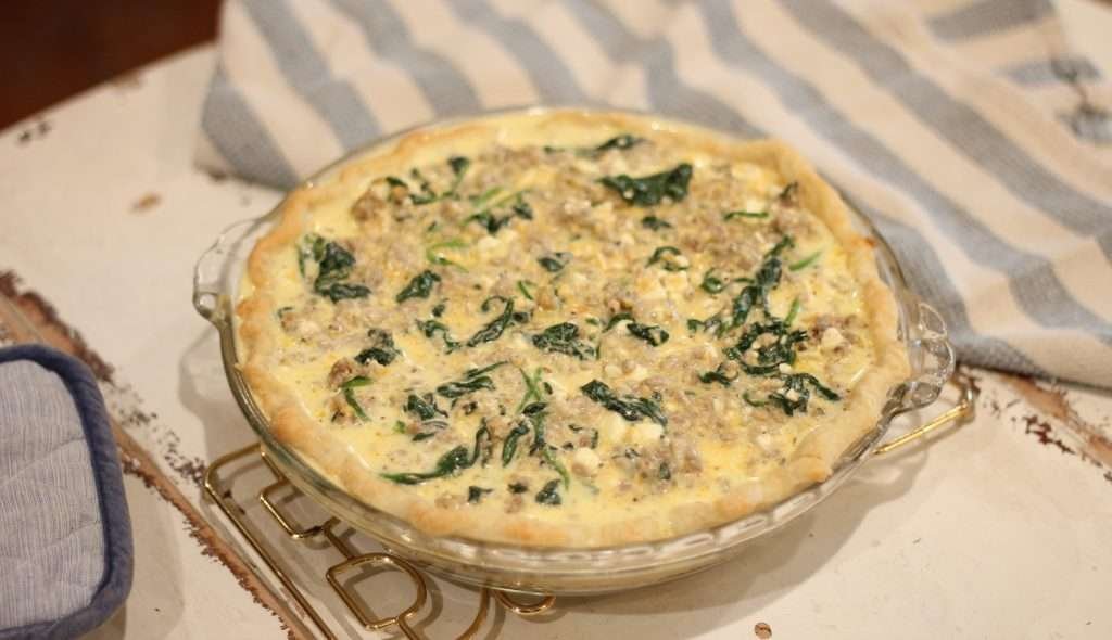 Sausage and spinach quiche in pan ready to cook