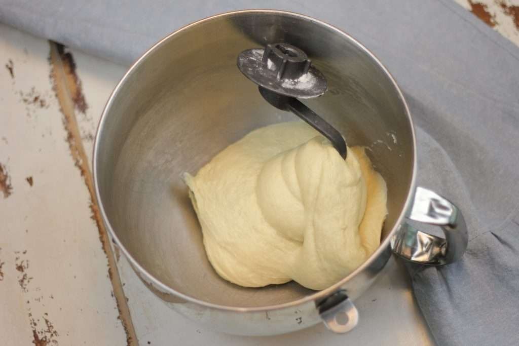 Braided Sweet Sourdough Butter and Egg Bread dough in mixing bowl with dough hook