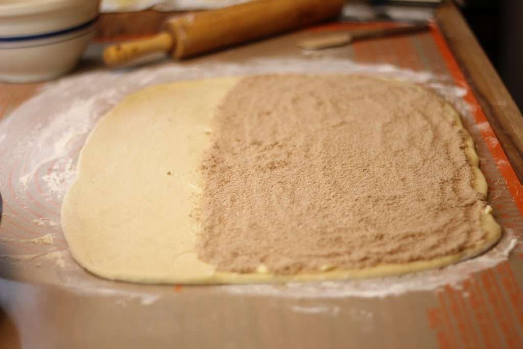 Cinnamon roll twist dough rolled out with cinnamon and sugar on 2/3rds of dough.