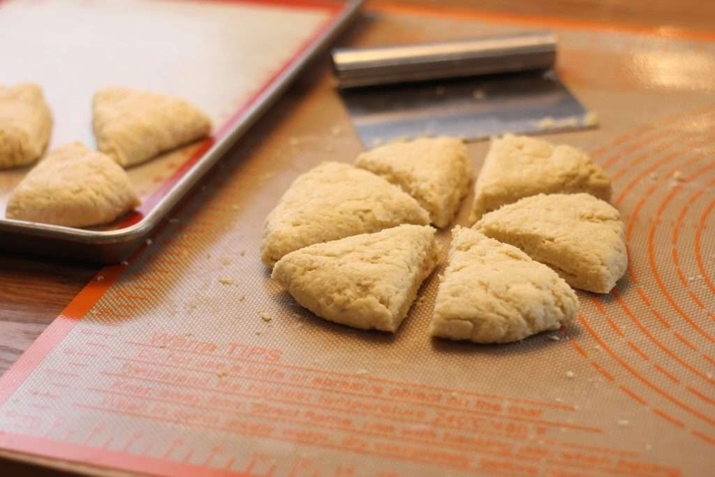 Eggnog Scones dough cut into triangles and put on pan. 