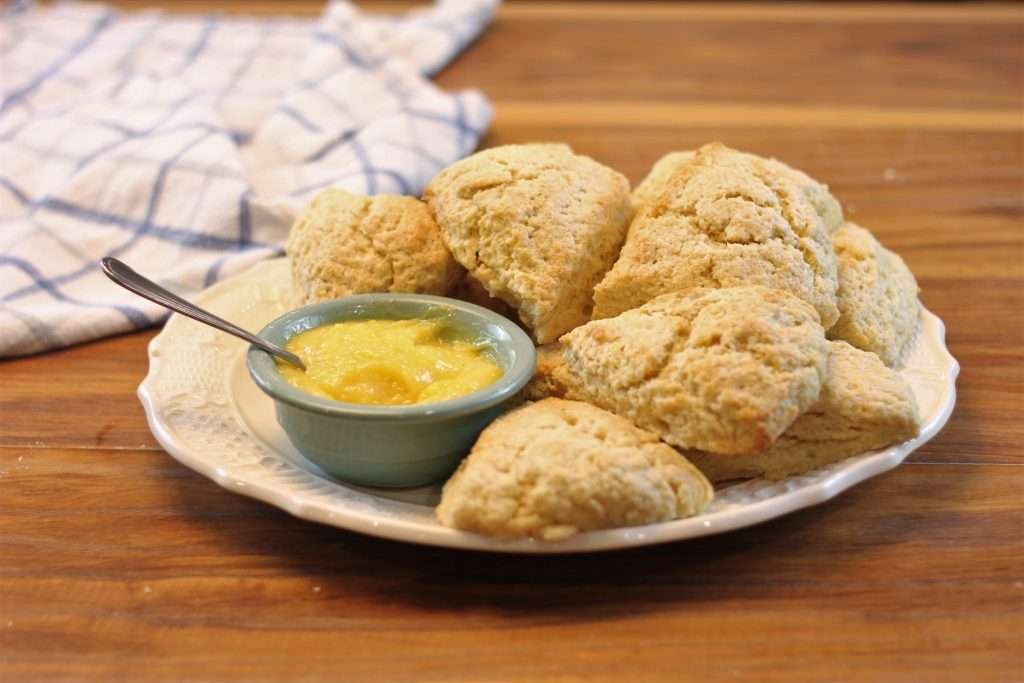 Eggnog Scottish Scones with a bowl of lemon curd on the side.