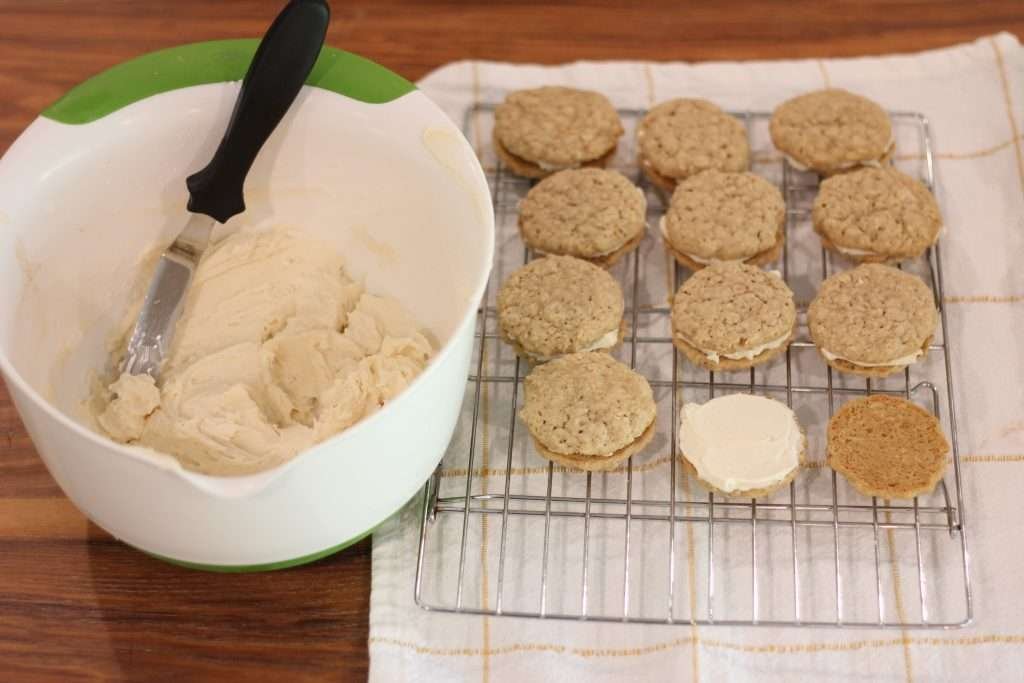 Oatmeal Cream Sandwich Cookie recipe with Sourdough on cooling rack with bowl of filling beside it. 