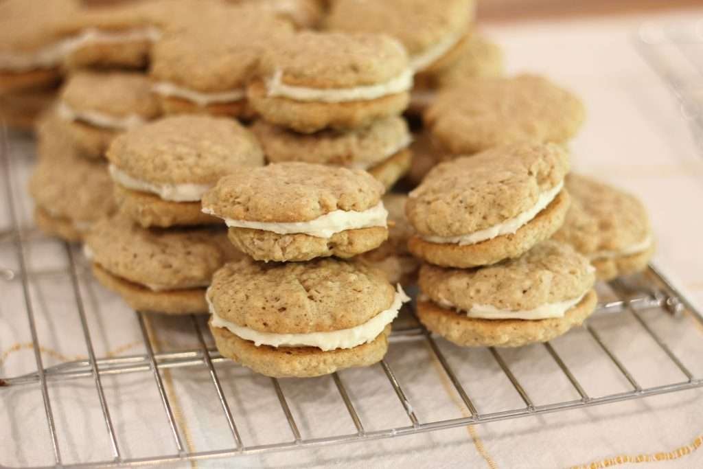 Stack of Oatmeal Cream Sandwich cookie recipe with sourdough on cooling rack. 