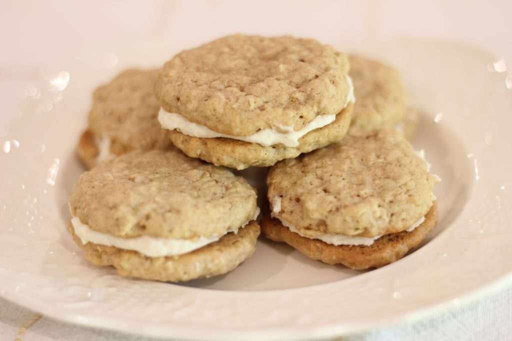 Close up of Oatmeal cream sandwich cookie recipe with sourdough on white plate. 