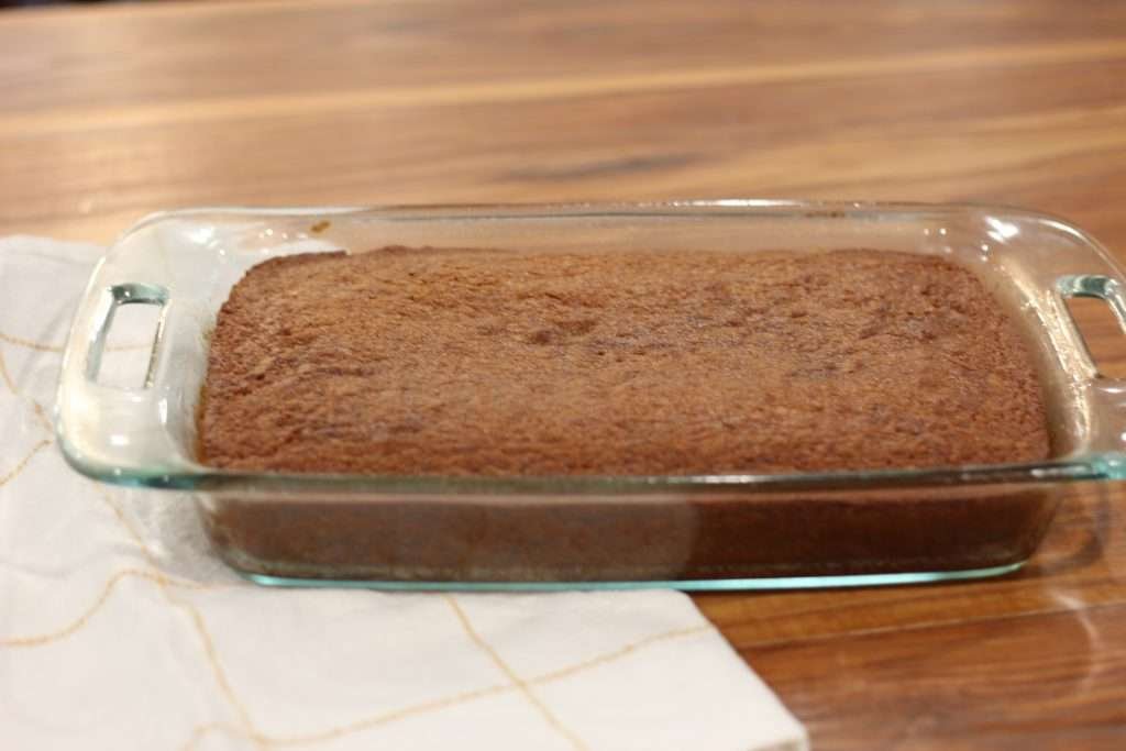 Baked applesauce spice cake recipe with sourdough discard in pan.