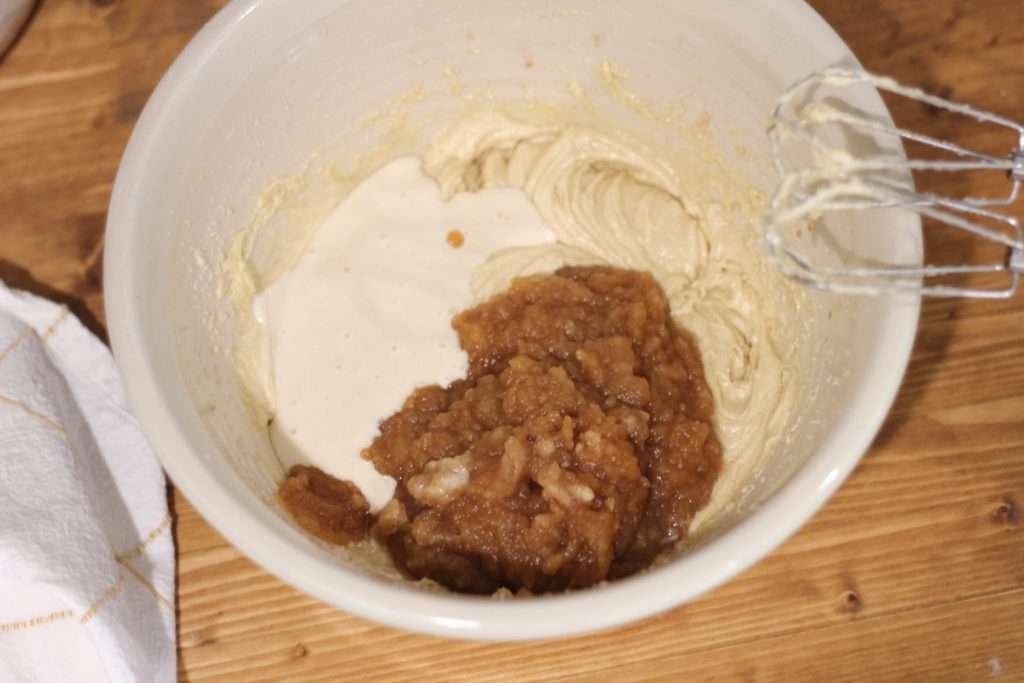 Sourdough discard and applesauce poured into cake batter.