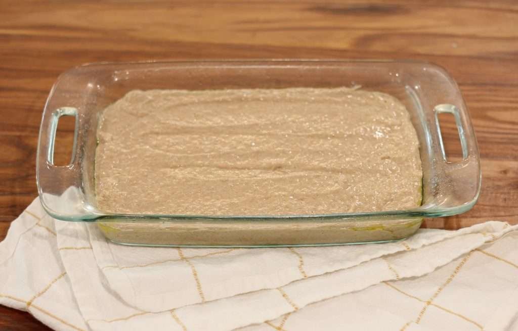 Applesauce spice cake recipe with sourdough discard batter in baking dish.